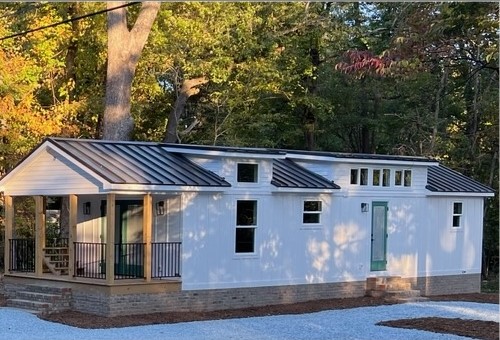 https://mustardseedtinyhomes.com/wp-content/uploads/2022/11/Sycamore-Modular-Tiny-Home-Installed-Mustard-Seed-Tiny-Homes-2022.jpg